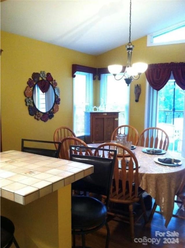 dining room with an inviting chandelier and lofted ceiling