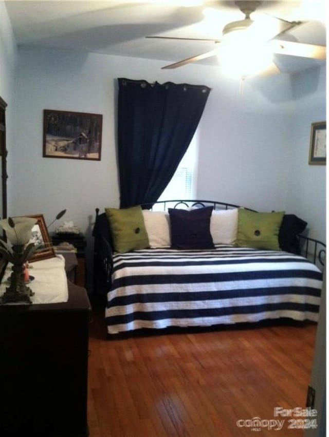 bedroom featuring dark hardwood / wood-style floors and ceiling fan