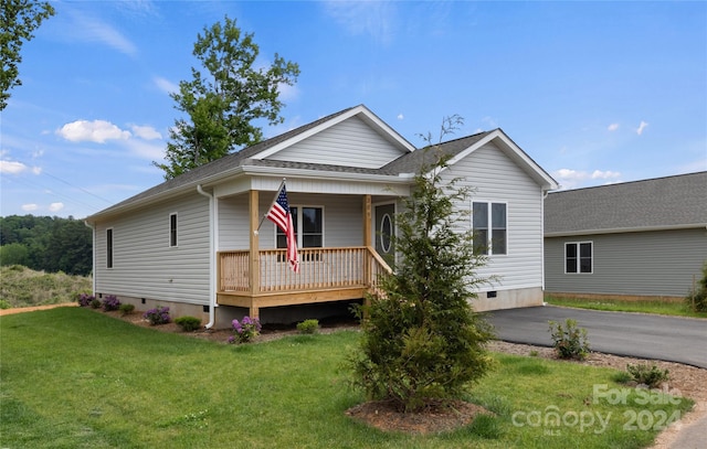 view of front of house featuring crawl space, a shingled roof, covered porch, and a front yard