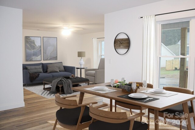 dining space with light wood finished floors and a ceiling fan
