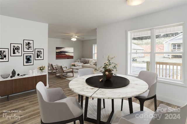 dining area with baseboards, wood finished floors, and ceiling fan