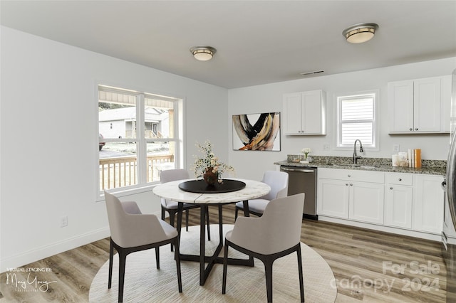 dining area featuring sink and light wood-type flooring