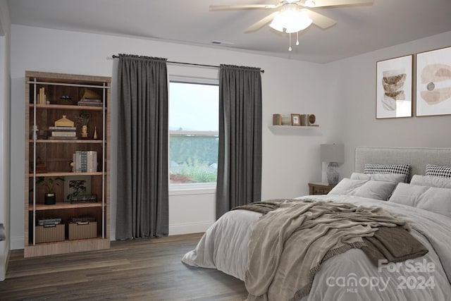 bedroom featuring ceiling fan, baseboards, wood finished floors, and visible vents