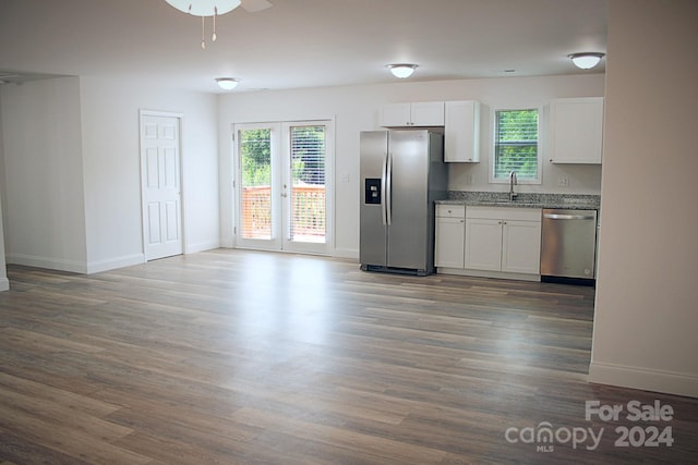 kitchen with white cabinets, hardwood / wood-style floors, sink, french doors, and appliances with stainless steel finishes