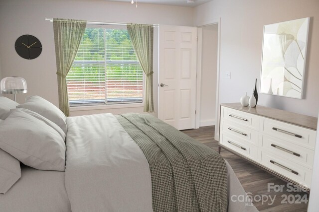 bedroom with dark hardwood / wood-style flooring