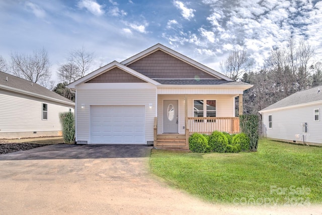 view of front of home with a garage and a front lawn