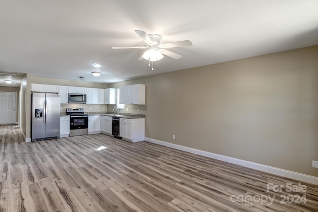 kitchen with stainless steel appliances, white cabinets, sink, light hardwood / wood-style floors, and ceiling fan