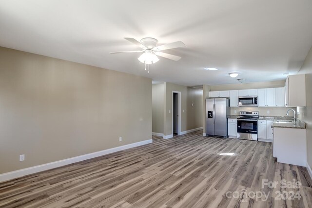 kitchen featuring light hardwood / wood-style floors, appliances with stainless steel finishes, white cabinetry, and ceiling fan