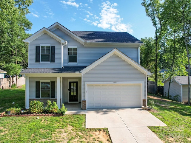 view of front facade featuring concrete driveway, fence, a front lawn, and roof with shingles