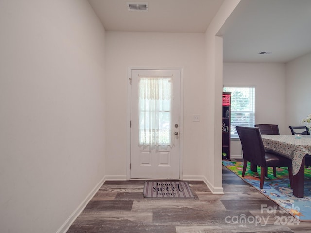 entrance foyer featuring visible vents, baseboards, and wood finished floors