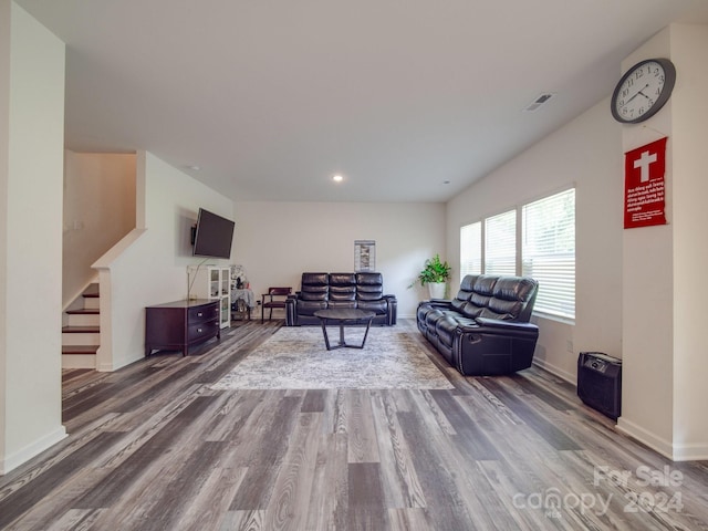 living area with visible vents, baseboards, stairway, recessed lighting, and wood finished floors