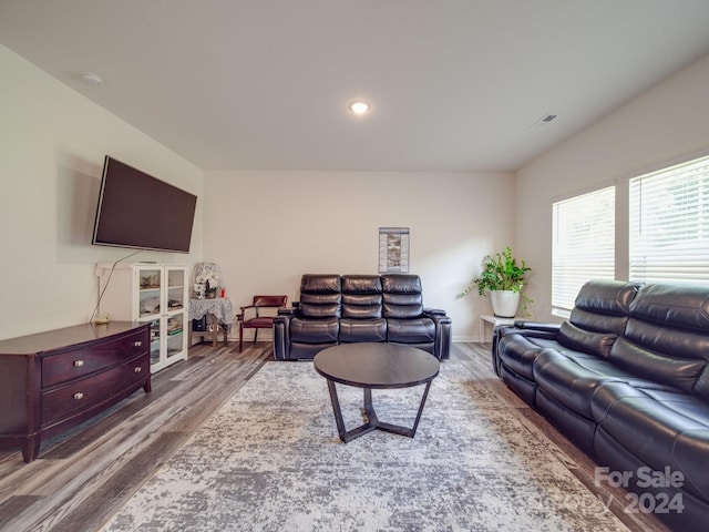 living area featuring recessed lighting, wood finished floors, and visible vents