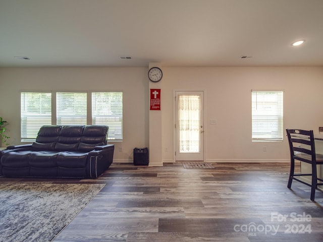 living room featuring recessed lighting, wood finished floors, baseboards, and a wealth of natural light