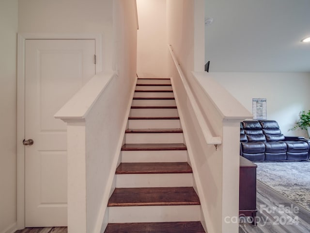 staircase with wood finished floors