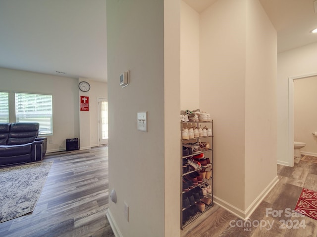 hall featuring baseboards and wood finished floors