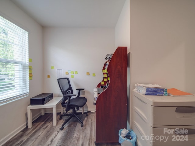 office space with baseboards and wood finished floors