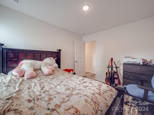 bedroom featuring wood finished floors