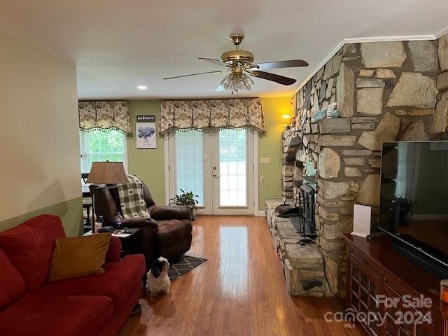 living room featuring a fireplace, french doors, ceiling fan, and hardwood / wood-style floors