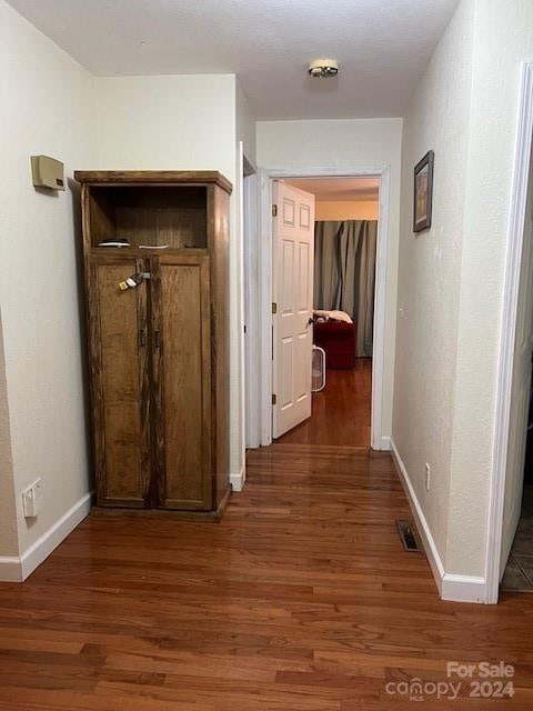 hallway with wood-type flooring