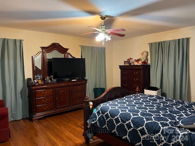 bedroom with ceiling fan and hardwood / wood-style flooring