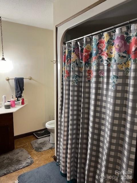 bathroom with tile patterned flooring, toilet, and vanity