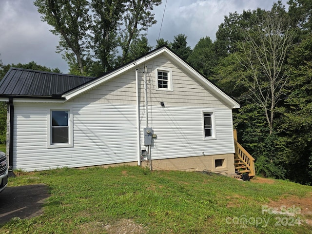 view of side of home featuring a yard