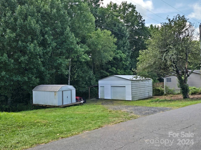 view of outdoor structure with a yard and a garage