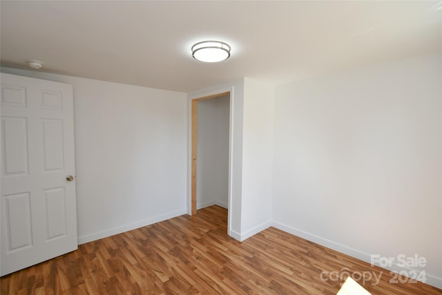 spare room with hardwood / wood-style floors