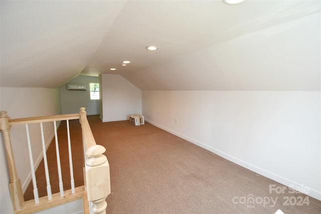 bonus room with lofted ceiling, carpet floors, and an AC wall unit