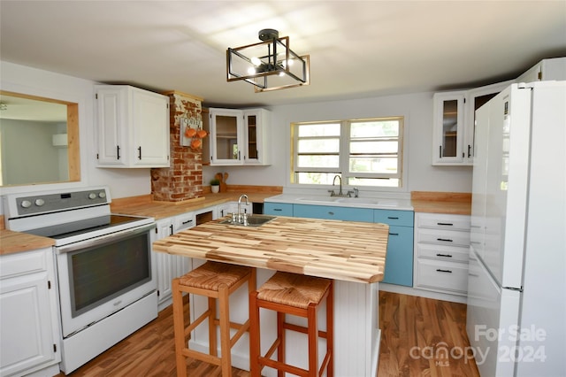 kitchen with white cabinetry and white appliances