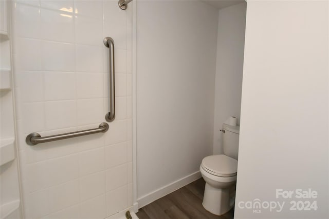 bathroom featuring hardwood / wood-style flooring and toilet