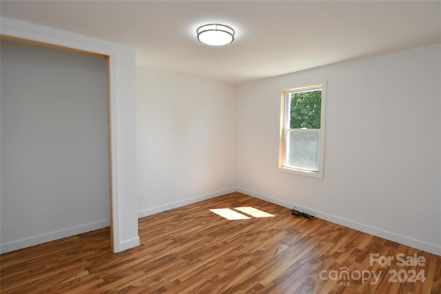 unfurnished room featuring wood-type flooring