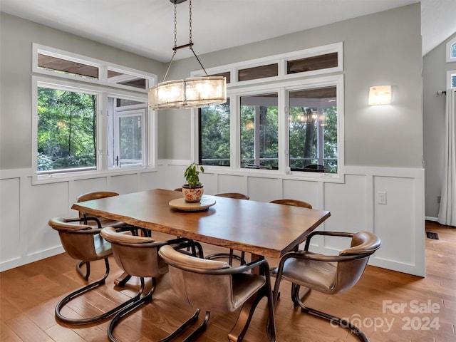 dining space featuring an inviting chandelier and light hardwood / wood-style flooring