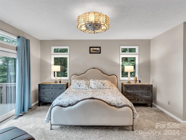 bedroom featuring a textured ceiling and carpet floors