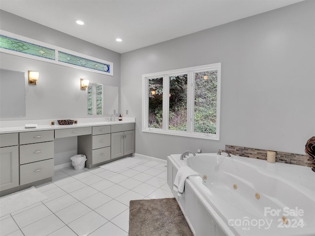 bathroom featuring tile patterned flooring, vanity, and a bath