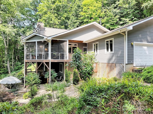 rear view of property with a sunroom