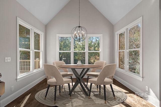 dining area with a chandelier, dark hardwood / wood-style flooring, plenty of natural light, and lofted ceiling