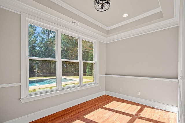 unfurnished room featuring hardwood / wood-style floors and ornamental molding