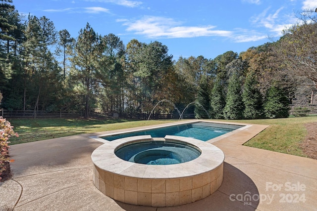 view of swimming pool featuring a lawn, an in ground hot tub, and a patio