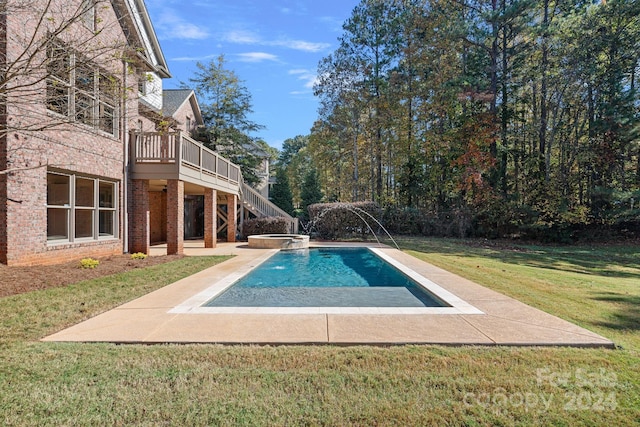 view of swimming pool featuring an in ground hot tub, a patio, pool water feature, and a lawn