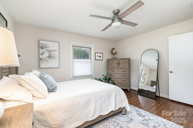 bedroom with a ceiling fan, baseboards, and wood finished floors