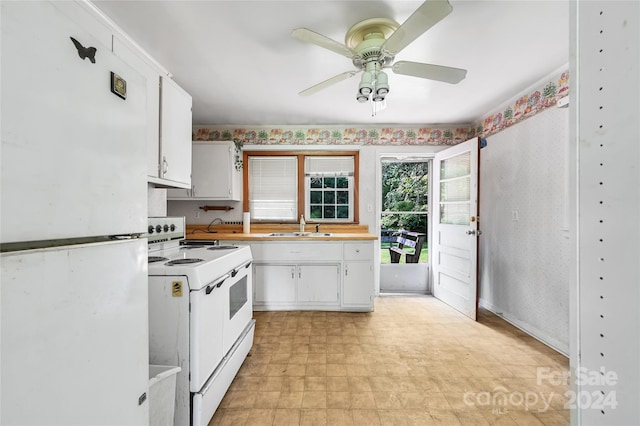 kitchen featuring ceiling fan, sink, white cabinets, and white appliances