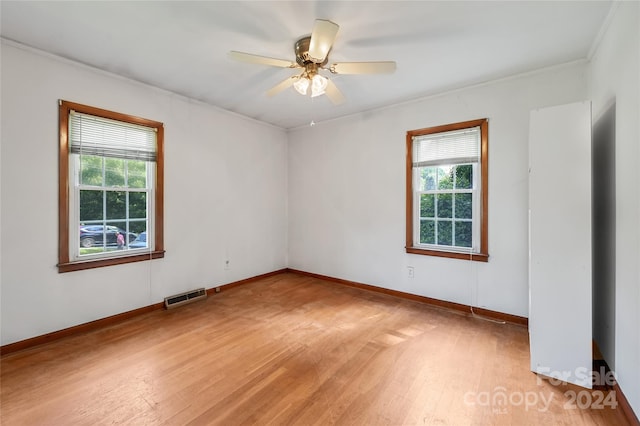 spare room with ceiling fan, light hardwood / wood-style floors, and a healthy amount of sunlight