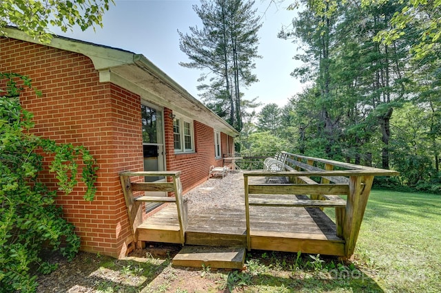 wooden terrace featuring a yard