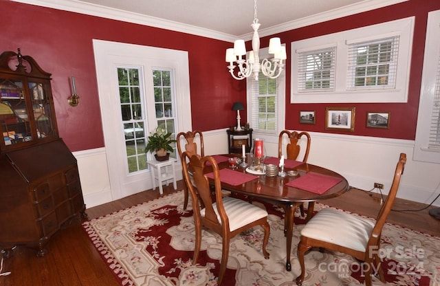 dining space with plenty of natural light, crown molding, dark hardwood / wood-style flooring, and a notable chandelier