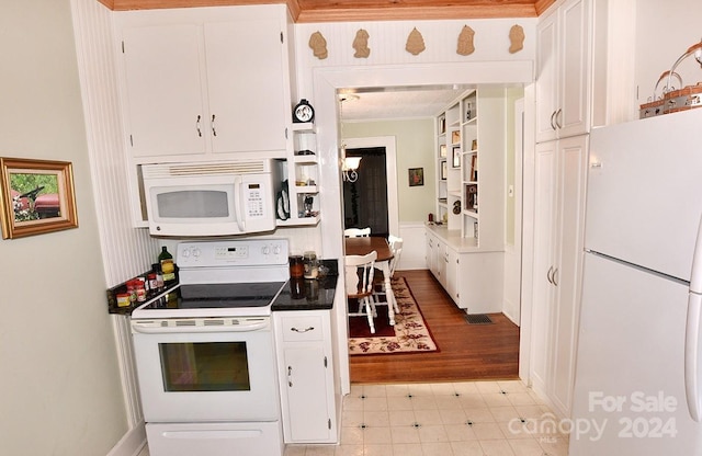 kitchen with ornamental molding, light tile patterned flooring, white cabinetry, and white appliances