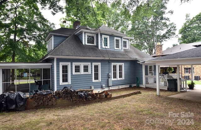 rear view of property with a yard