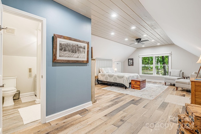 bedroom with vaulted ceiling, light wood-style flooring, baseboards, and visible vents