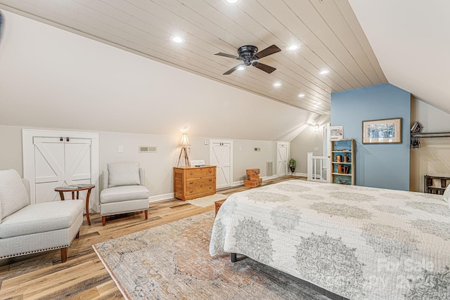 bedroom featuring wood finished floors, visible vents, baseboards, lofted ceiling, and recessed lighting