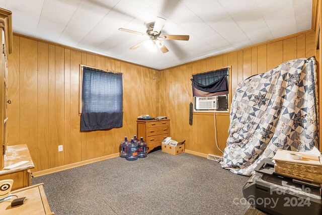 misc room with wood walls, carpet, ceiling fan, and cooling unit